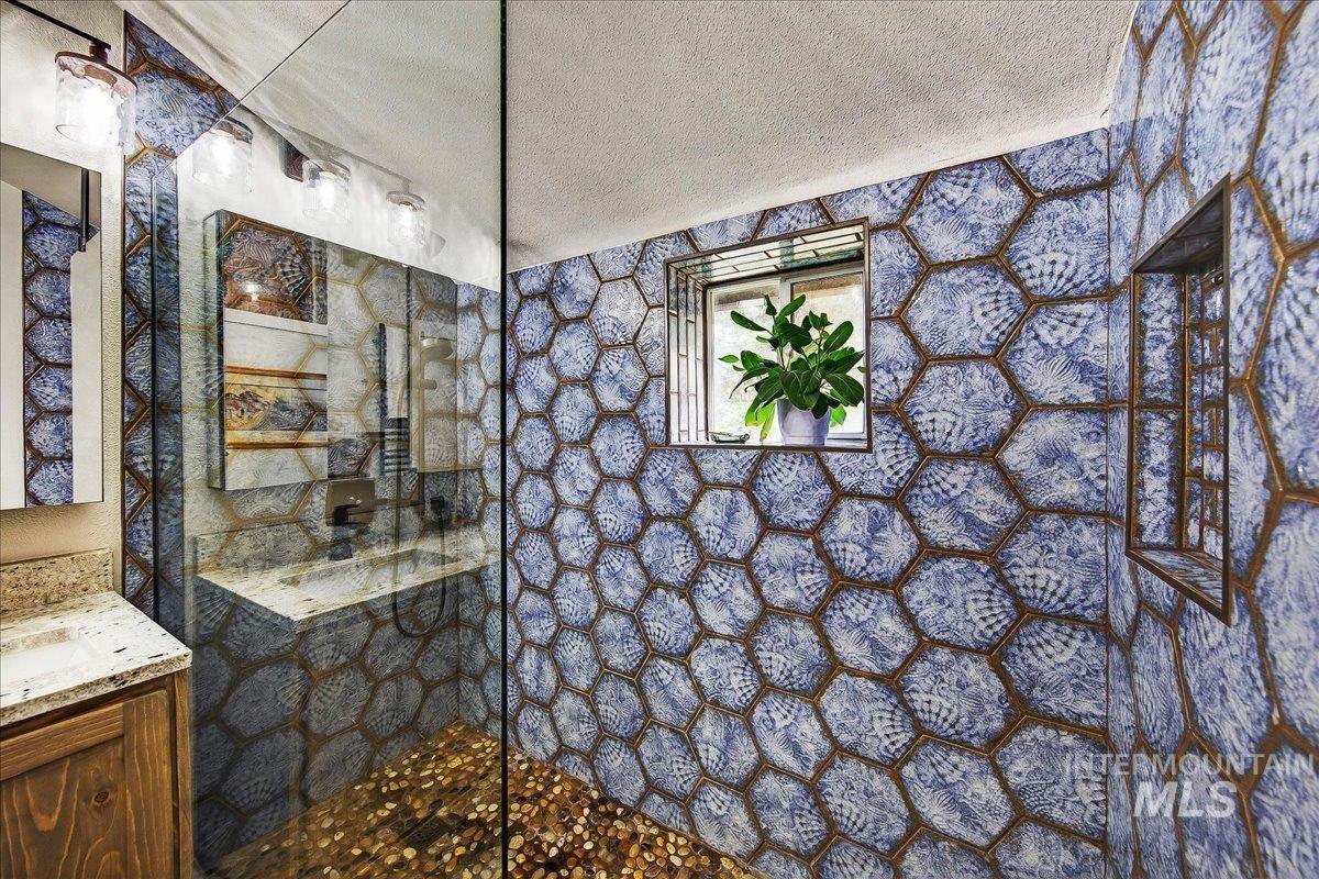239 Tollgate Road Boise, ID 83716 - Photo 10 of 50 Bathroom featuring a textured ceiling, a walk in shower, and vanity