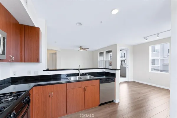 a kitchen with stainless steel appliances granite countertop a sink and a stove