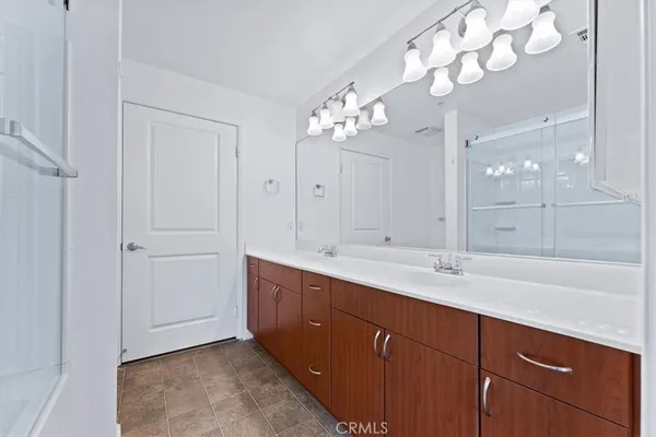 a bathroom with a shower and a sink