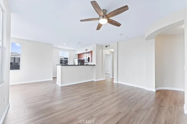 a view of empty room with wooden floor