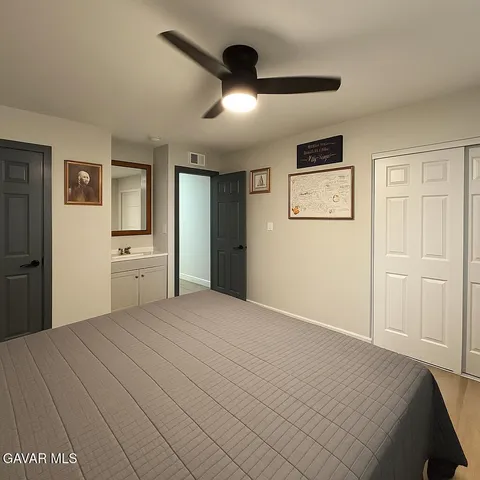 a bedroom with a large bed and a chandelier