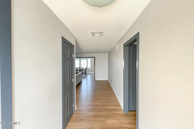 a view of hallway with wooden floor
