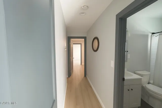 a view of a bathroom from a hallway