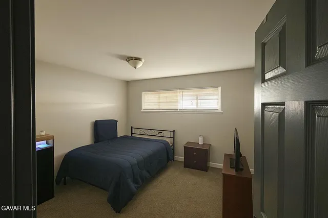a bedroom with a bed and window
