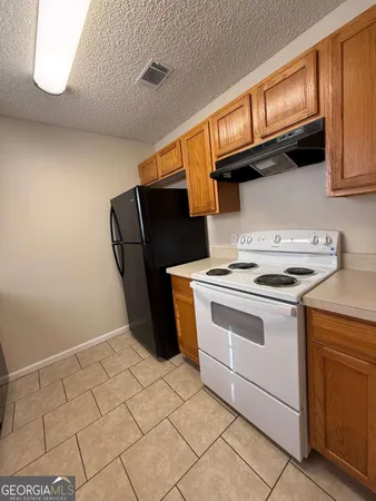 a bedroom with a bed and a chandelier fan