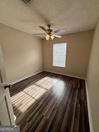 a view of a room with wooden floor