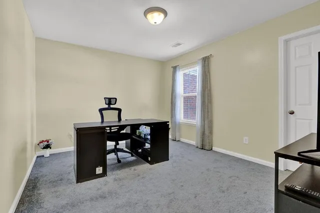 a view of a workspace with furniture