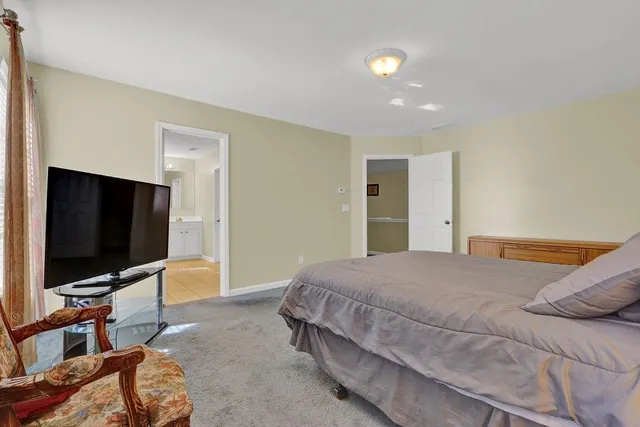 a bedroom with a bed and a chair