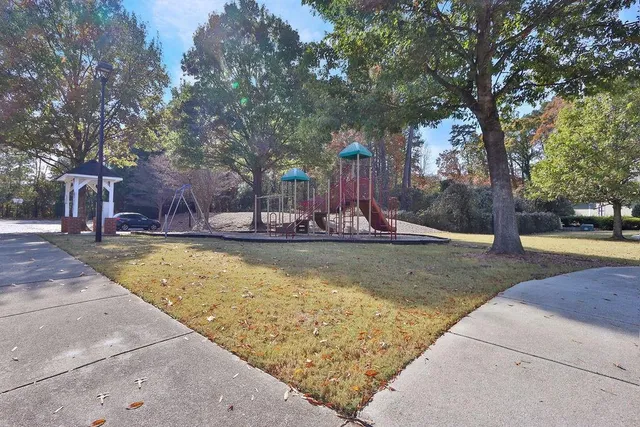a front view of a house with a yard and a garage
