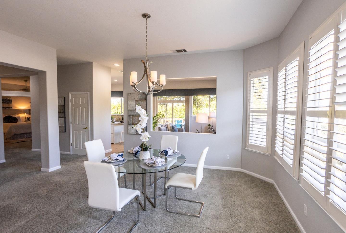 2049 Folle Blanche Drive San Jose, CA 95135 - Photo 4 of 42 a dining room with furniture a chandelier and wooden floor