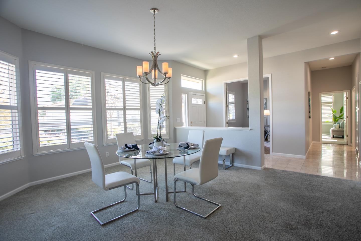 2049 Folle Blanche Drive San Jose, CA 95135 - Photo 5 of 42 a dining room with furniture a chandelier and wooden floor