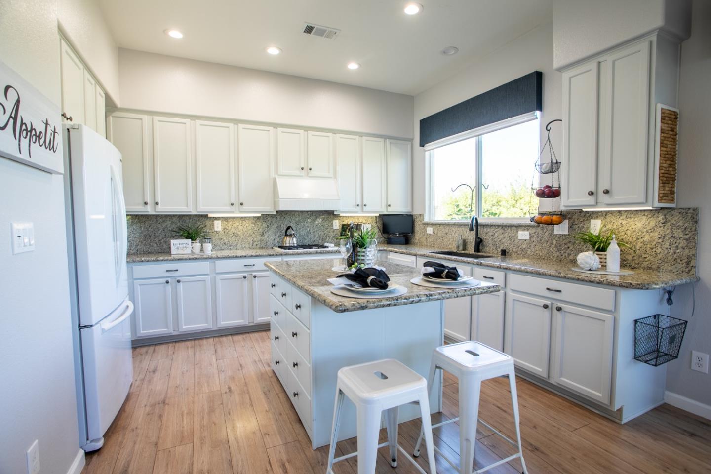 2049 Folle Blanche Drive San Jose, CA 95135 - Photo 10 of 42 a kitchen with stainless steel appliances granite countertop a stove a sink dishwasher a refrigerator and white cabinets with wooden floor