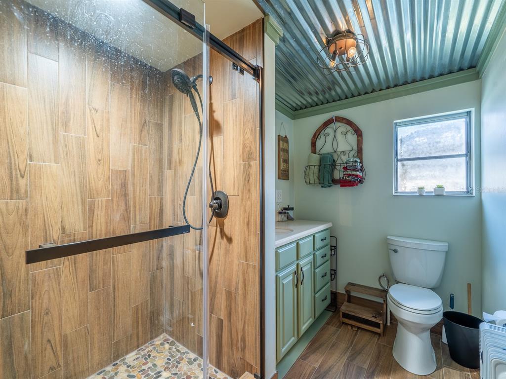 24855 Northeast 135th Street Salt Springs, FL 32134 - Photo 11 of 53 a bathroom with a toilet a sink and shower