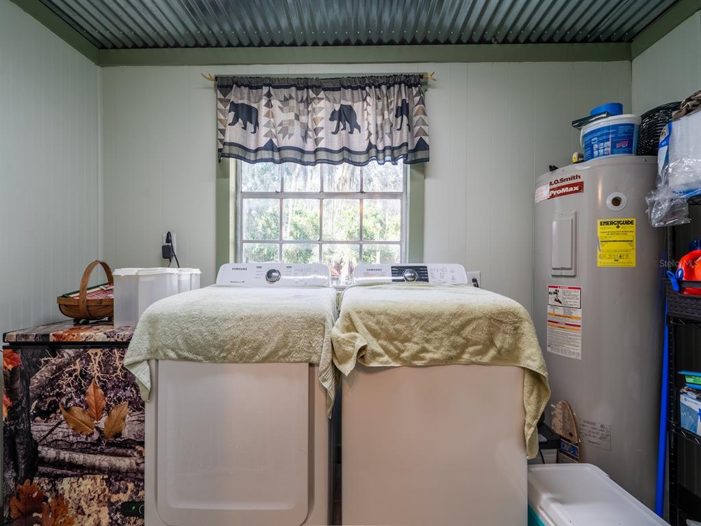 24855 Northeast 135th Street Salt Springs, FL 32134 - Photo 20 of 53 a bed sitting in a bedroom next to a window