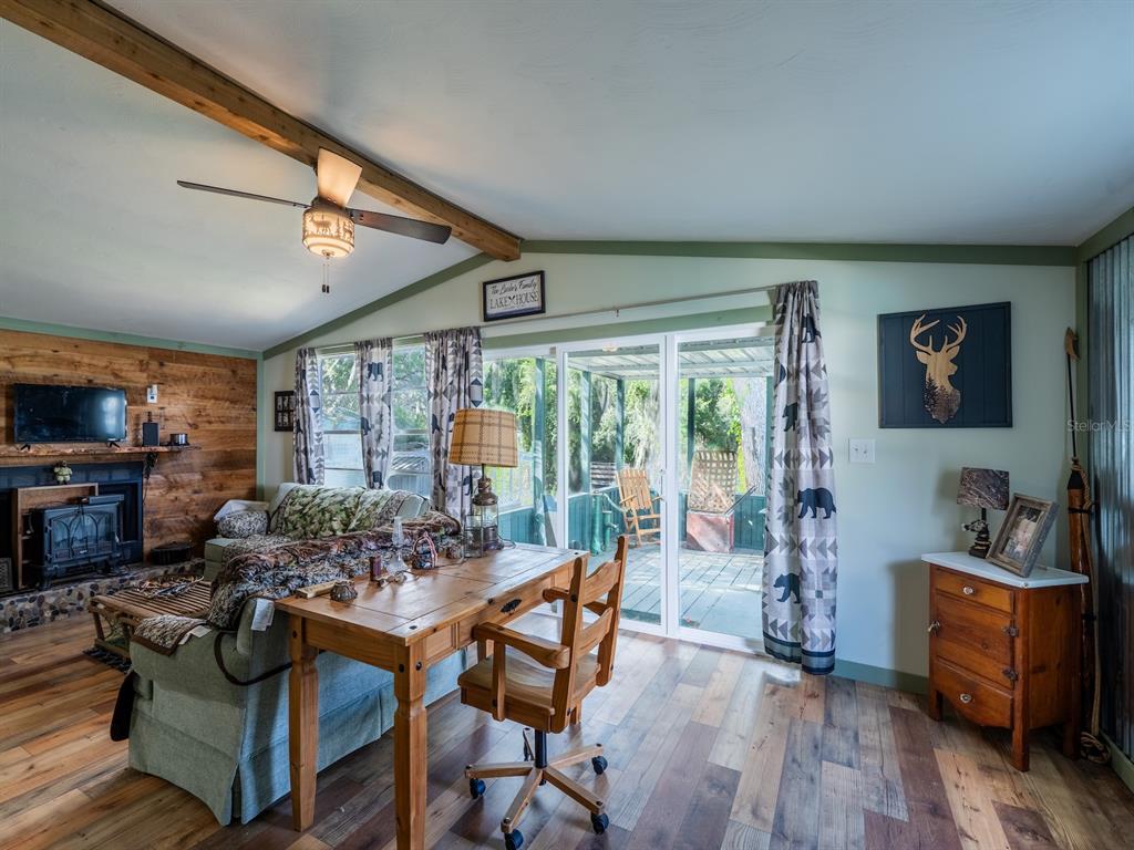 24855 Northeast 135th Street Salt Springs, FL 32134 - Photo 31 of 53 a living room with furniture and a flat screen tv