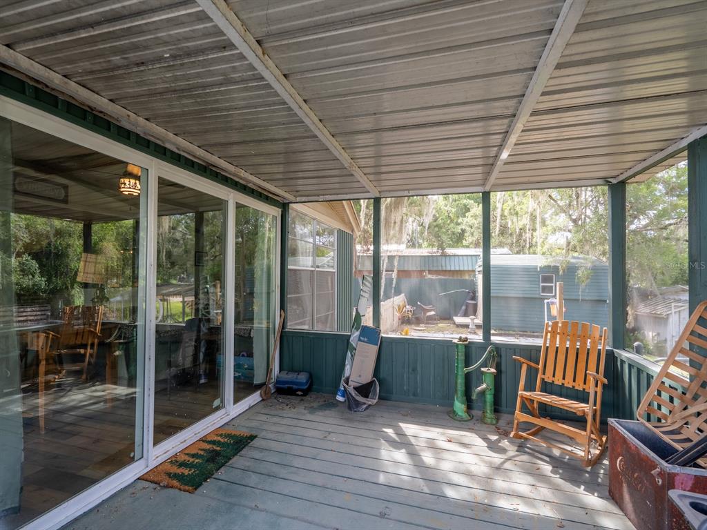 24855 Northeast 135th Street Salt Springs, FL 32134 - Photo 33 of 53 a view of a deck with wooden floor and outdoor seating