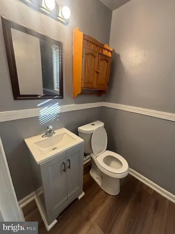 a bathroom with a toilet a sink and mirror