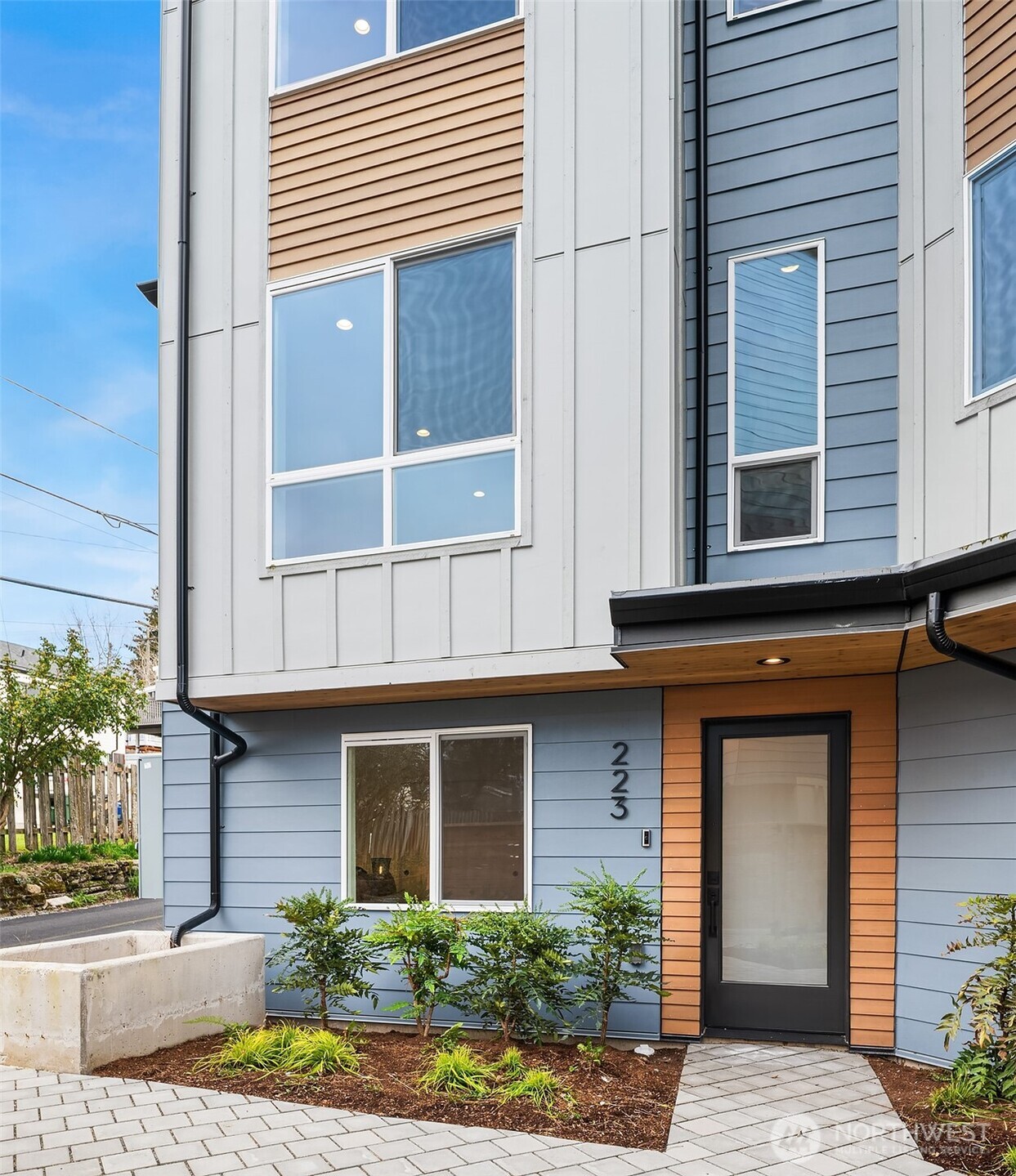 a view of brick house with potted plants