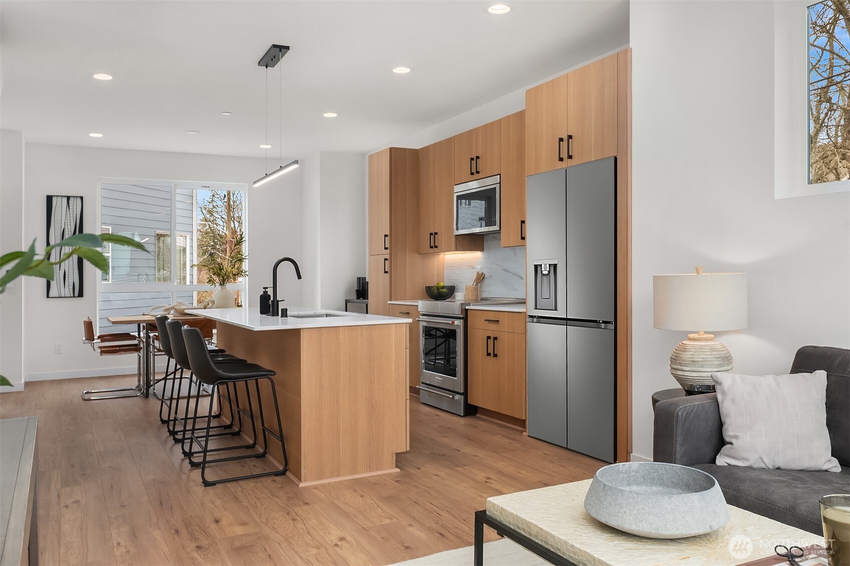 223 Northeast 75th Street Seattle, WA 98115 - Photo 12 of 33 a kitchen with refrigerator and chairs