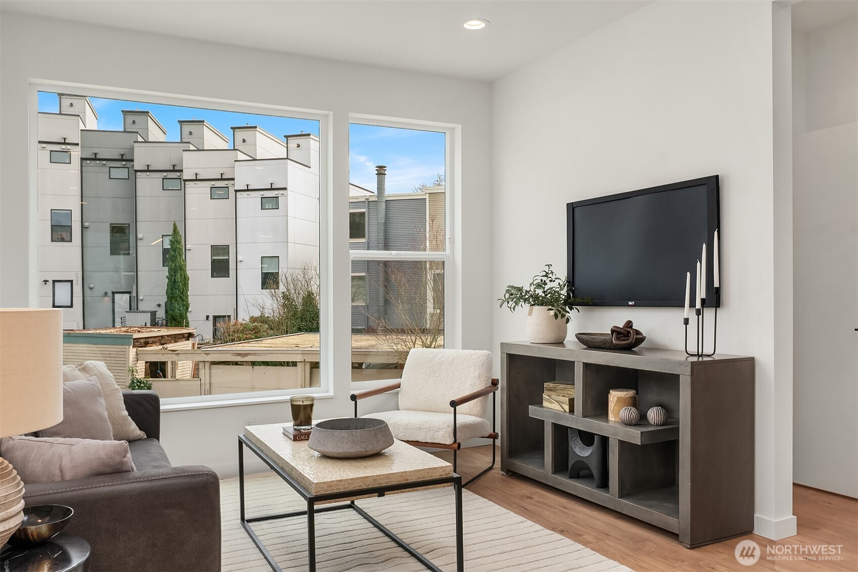223 Northeast 75th Street Seattle, WA 98115 - Photo 13 of 33 a living room with furniture a flat screen tv and large window