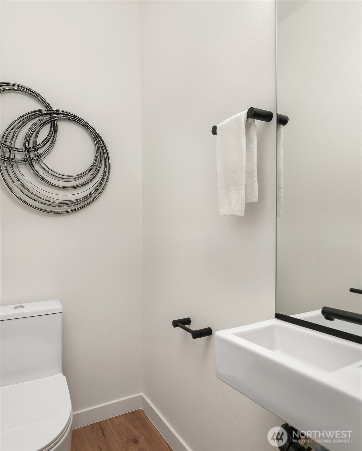 223 Northeast 75th Street Seattle, WA 98115 - Photo 15 of 33 a bathroom with a sink a toilet and a mirror