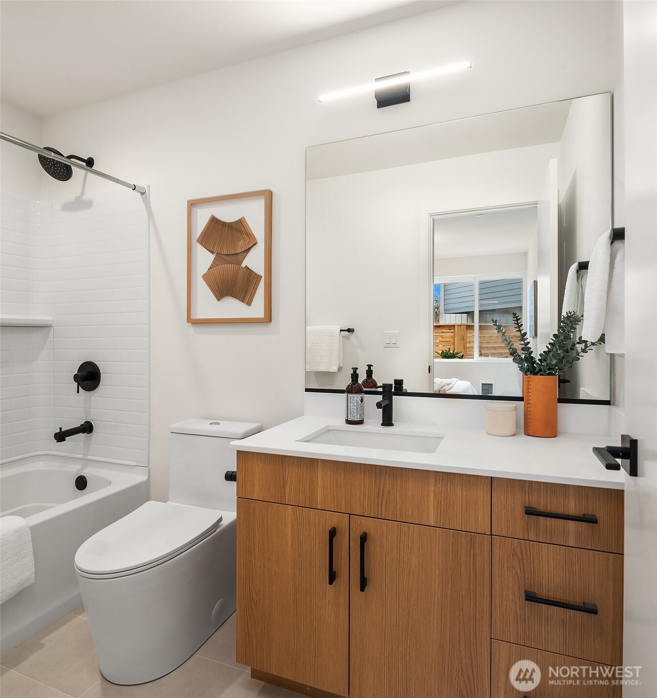 223 Northeast 75th Street Seattle, WA 98115 - Photo 18 of 33 a bathroom with a toilet a sink a tub and mirror