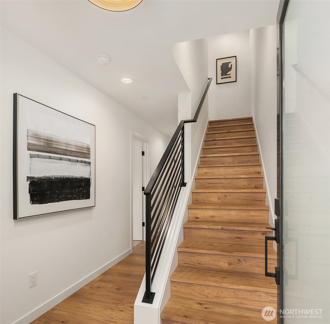 223 Northeast 75th Street Seattle, WA 98115 - Photo 2 of 33 a view of a hallway with wooden floor and entryway