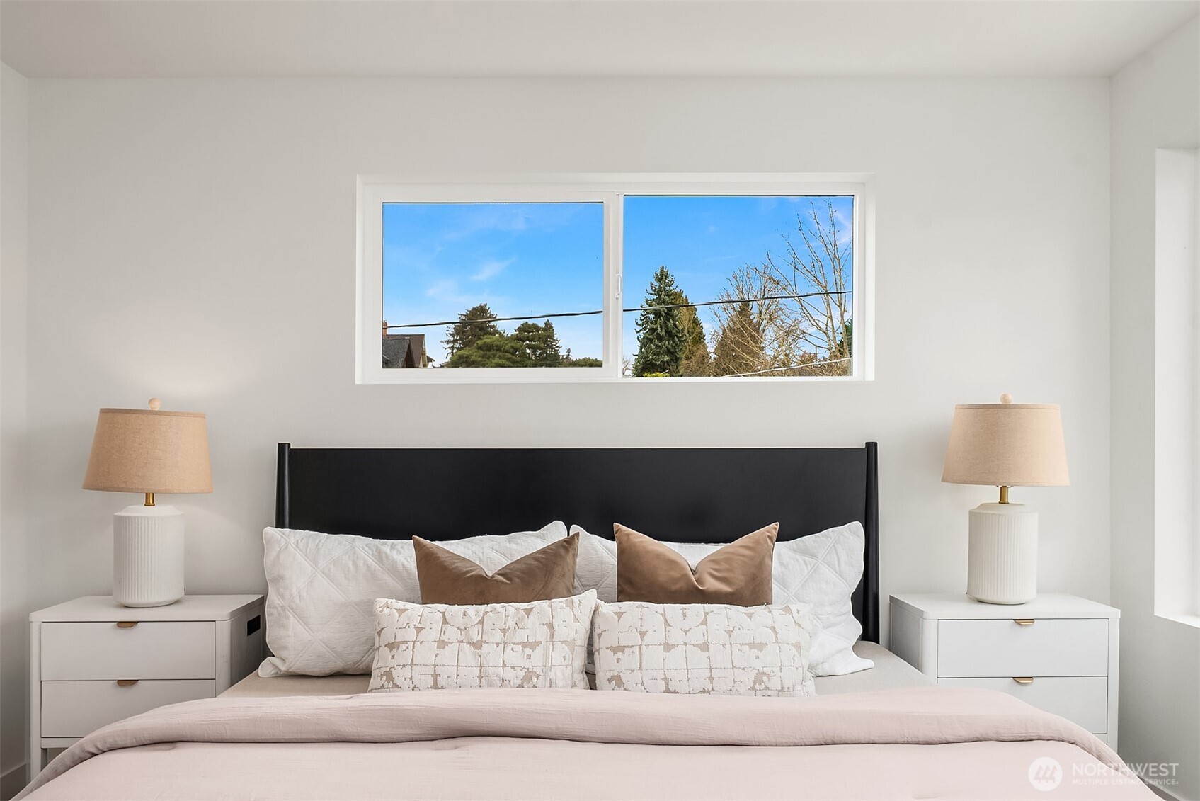 223 Northeast 75th Street Seattle, WA 98115 - Photo 24 of 33 a bed with a white comforter and pillows