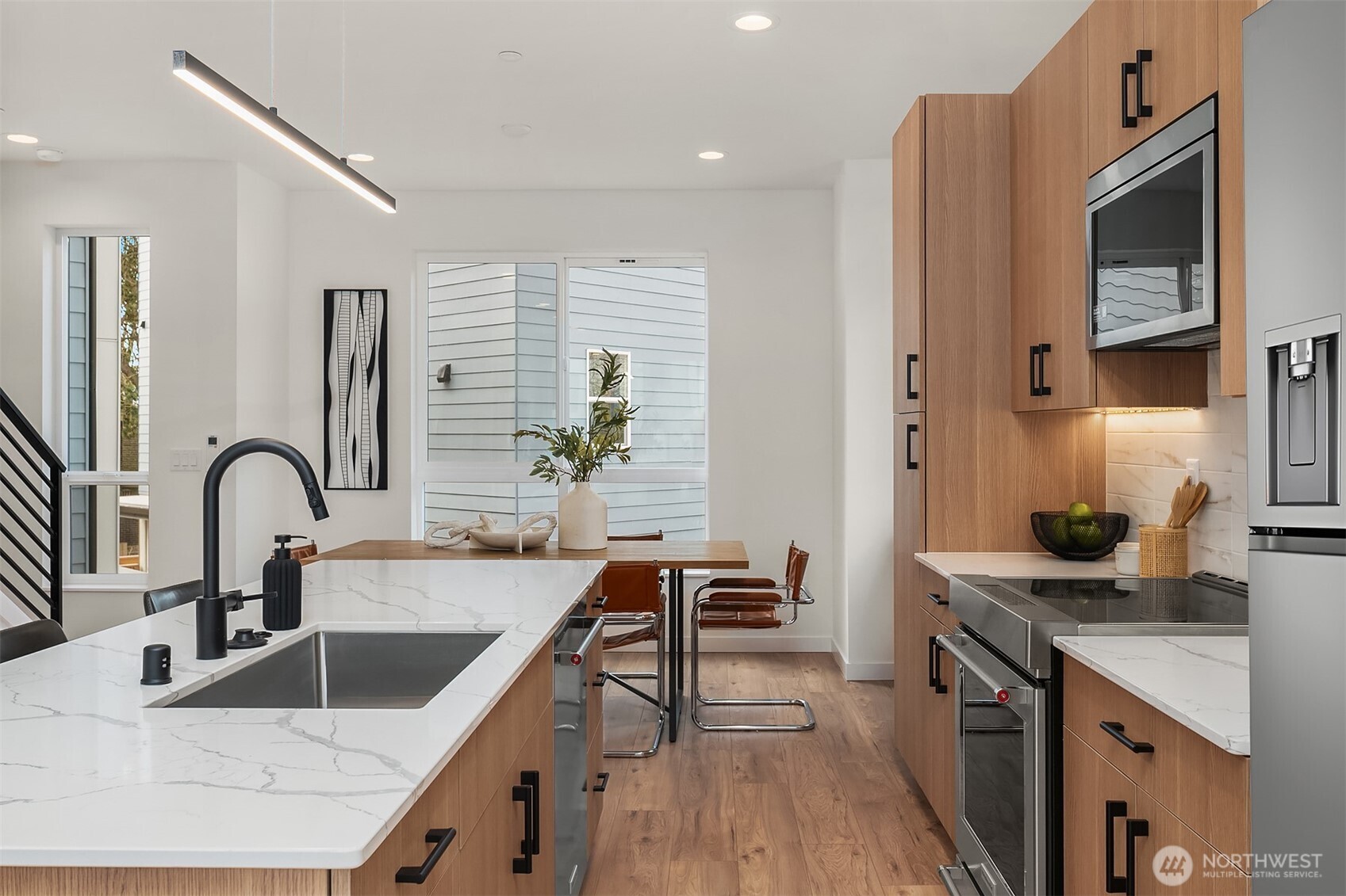 223 Northeast 75th Street Seattle, WA 98115 - Photo 5 of 33 a kitchen with granite countertop a sink a counter space appliances and cabinets