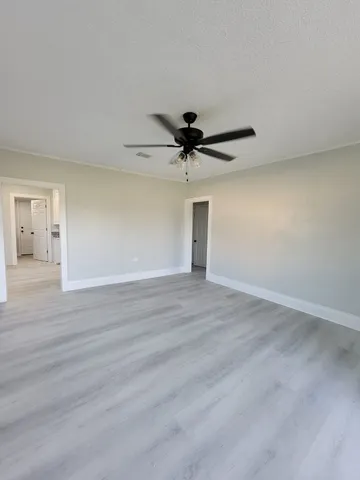 a view of a livingroom with a hardwood floor and a ceiling fan