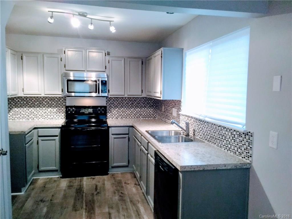 5832 Vernedale Road Charlotte, NC 28212 - Photo 3 of 16 a kitchen with a sink stove and refrigerator