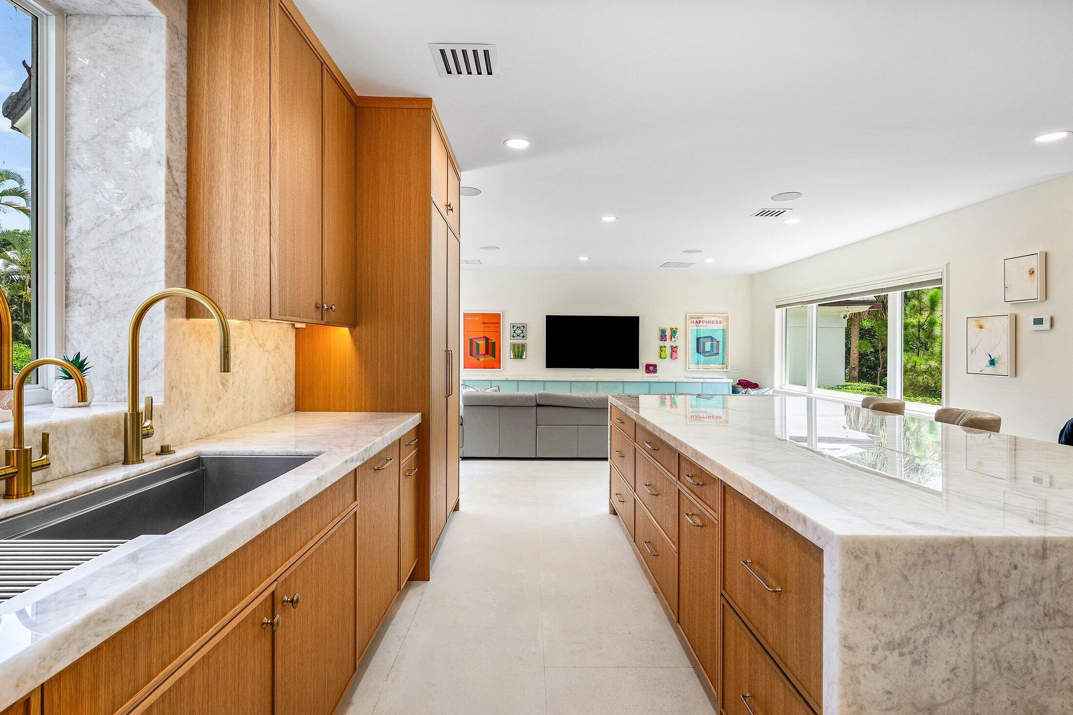 5 Osprey Court Ocean Ridge, FL 33435 - Photo 16 of 39 a large kitchen with kitchen island a sink and a stove top oven