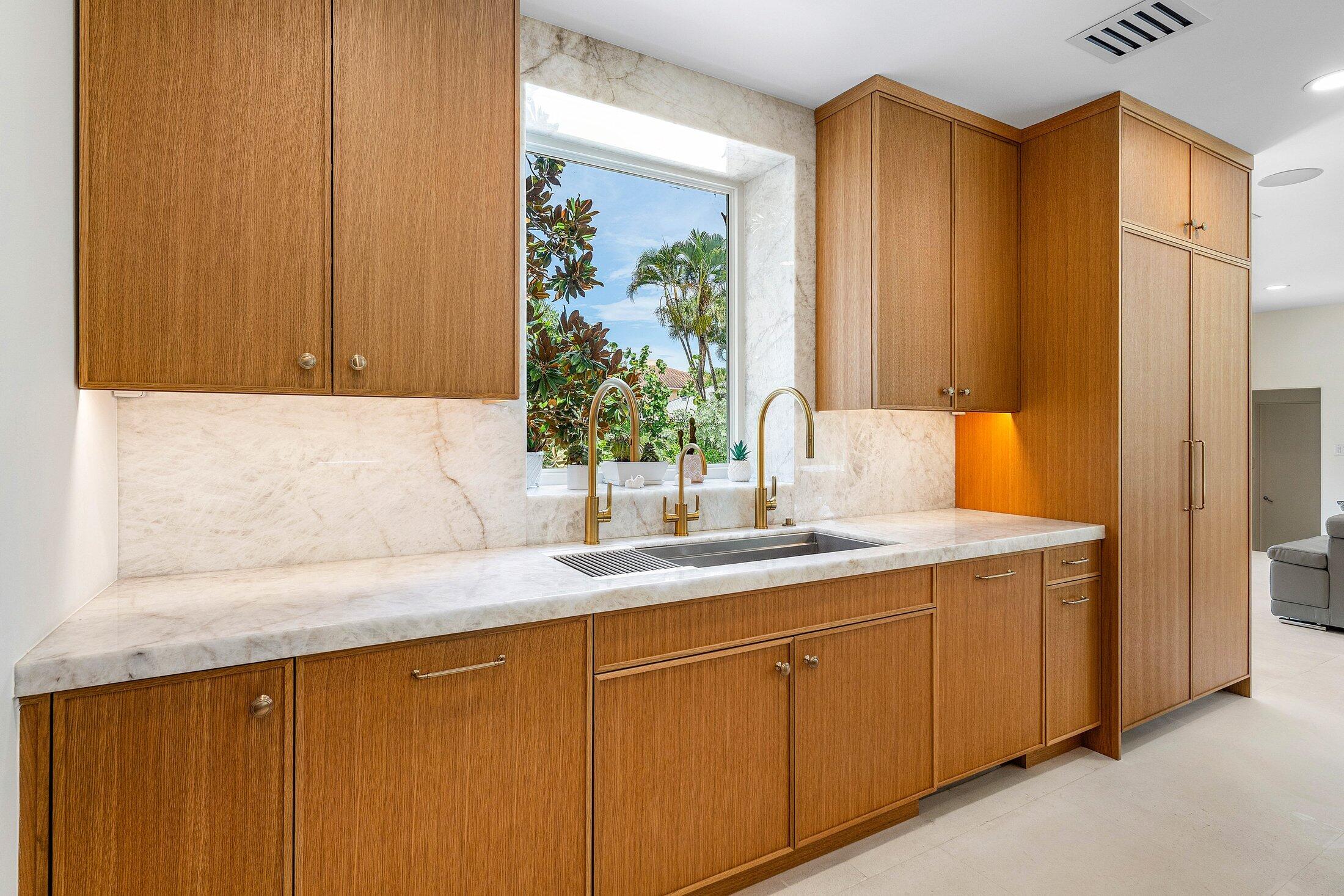 5 Osprey Court Ocean Ridge, FL 33435 - Photo 18 of 39 a kitchen with a sink and cabinets