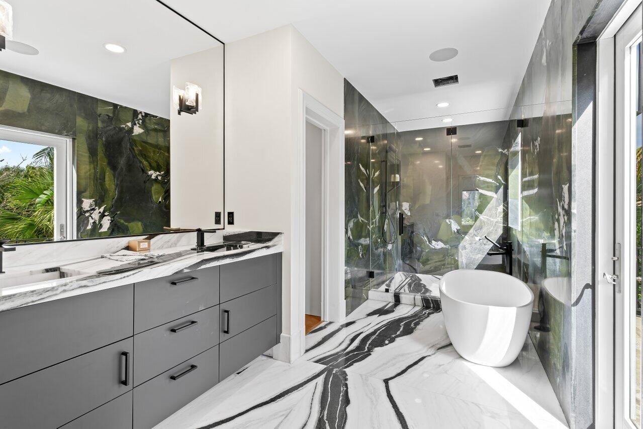 5 Osprey Court Ocean Ridge, FL 33435 - Photo 28 of 39 a bathroom with a double vanity sink toilet and shower