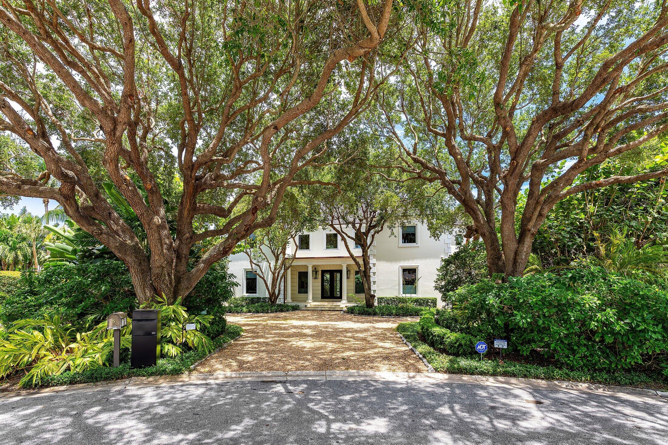 5 Osprey Court Ocean Ridge, FL 33435 - Photo 3 of 39 a white house with a tree in front of it