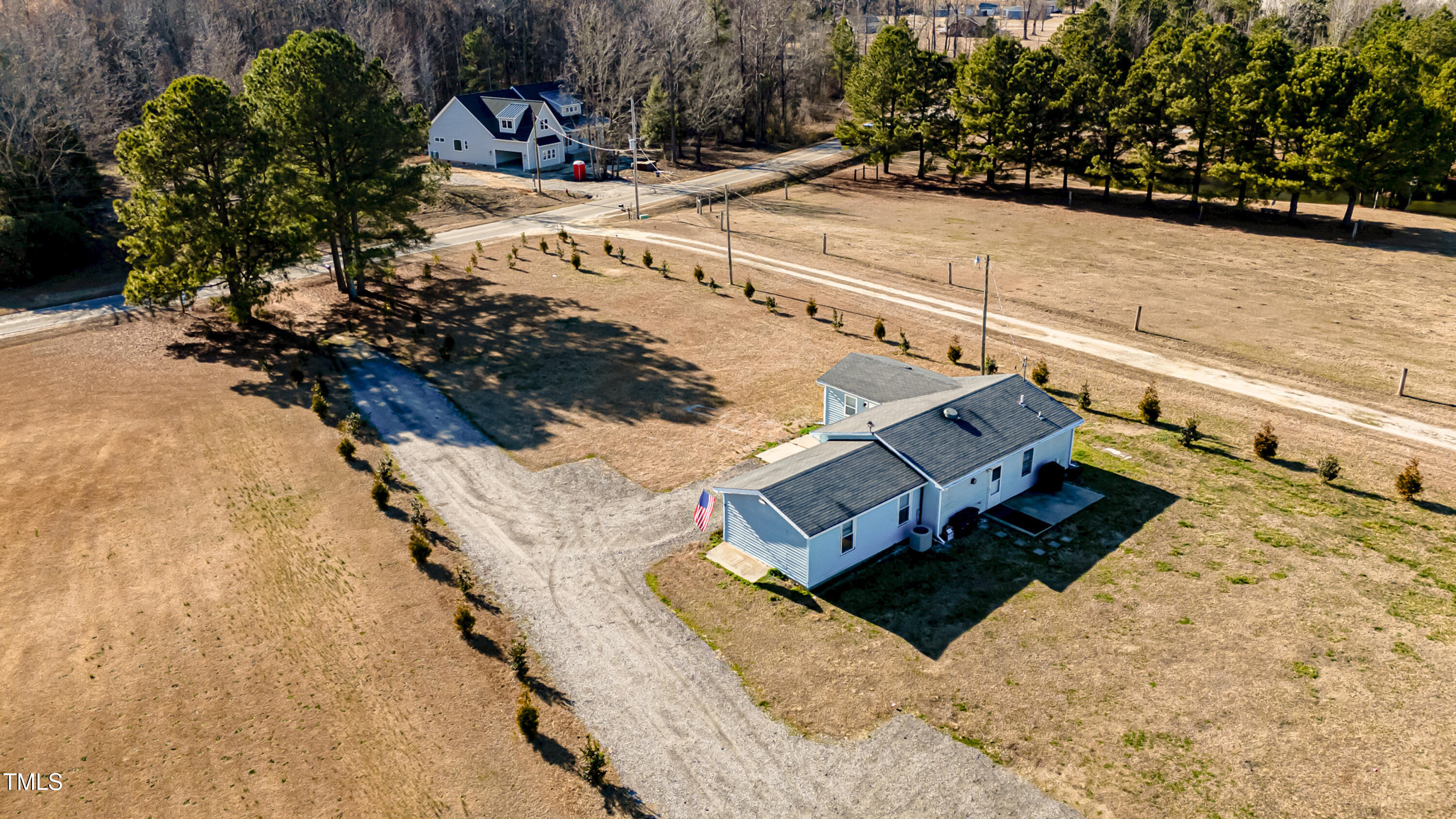a view of a yard with wooden fence