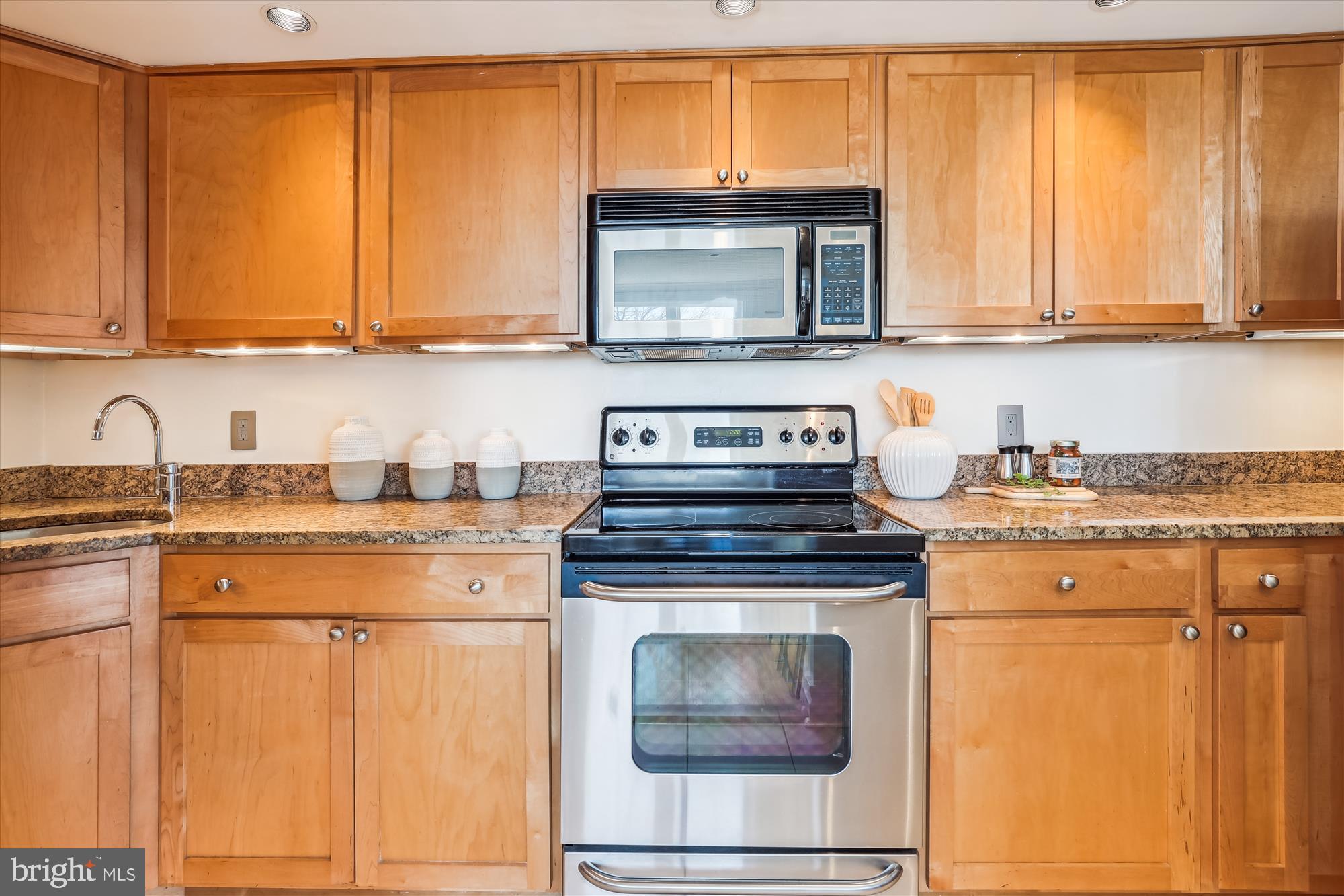2630 Adams Mill Road Northwest, Unit 209 Washington, DC 20009 - Photo 13 of 47 a kitchen with granite countertop cabinets stainless steel appliances and a sink