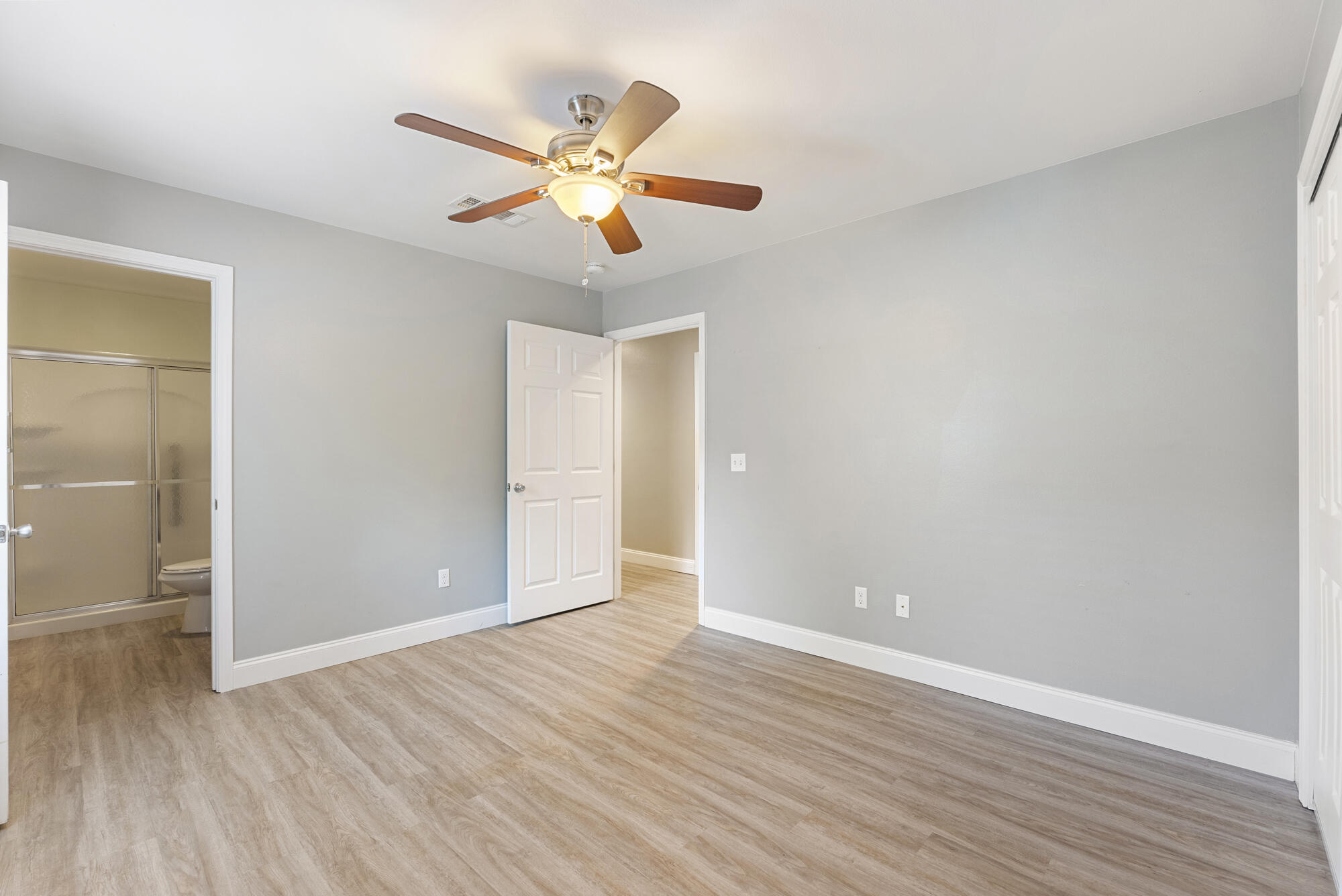 59 6th Street Santa Rosa Beach, FL 32459 - Photo 19 of 43 an empty room with wooden floor fan and windows