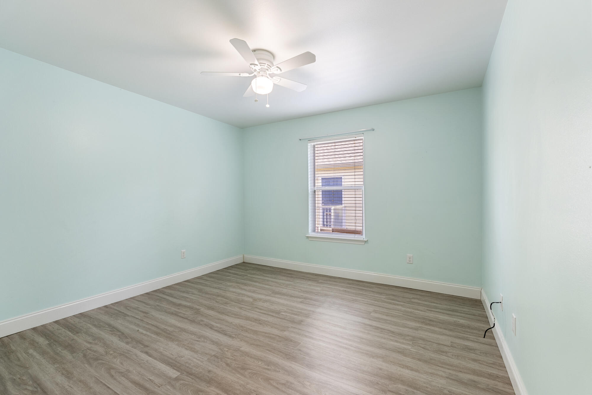 59 6th Street Santa Rosa Beach, FL 32459 - Photo 23 of 43 an empty room with wooden floor and windows