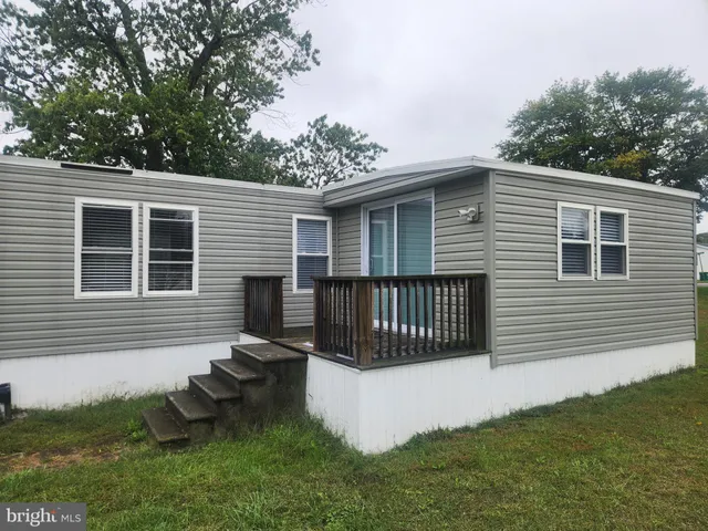 a view of a house with a yard and a garden