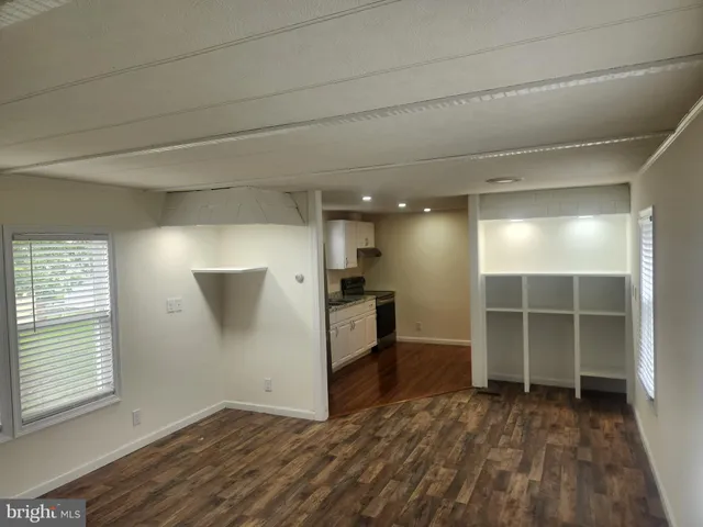 a view of a kitchen with wooden floor and a sink