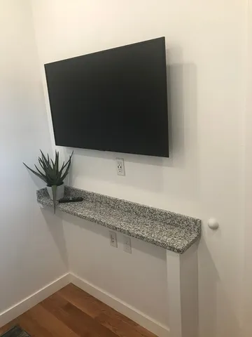 a close view of a sink a mirror and cabinets