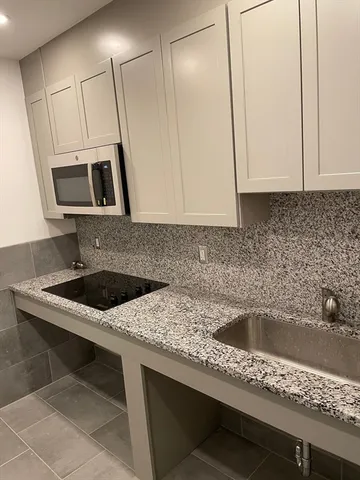 a kitchen with a sink and a microwave