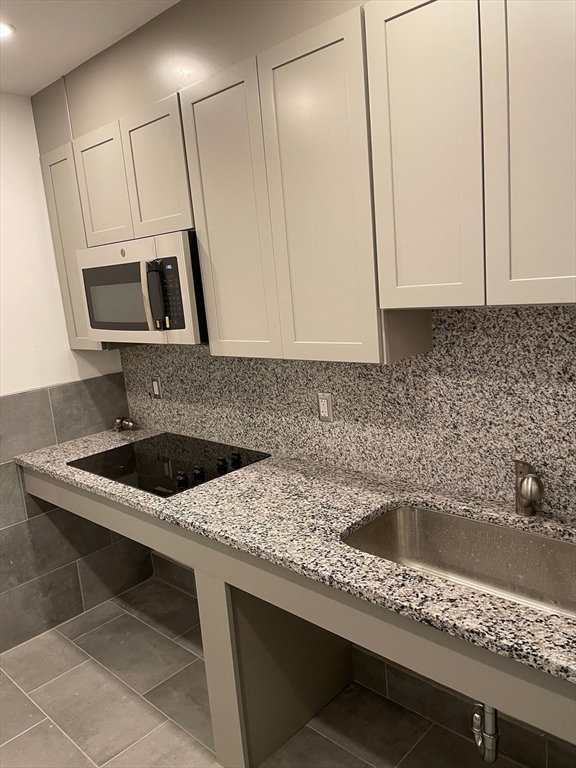69 North Common Street, Unit 3 Lynn, MA 01902 - Photo 4 of 15 a kitchen with a sink and a microwave