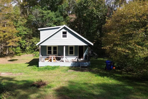a front view of house with outdoor seating and yard