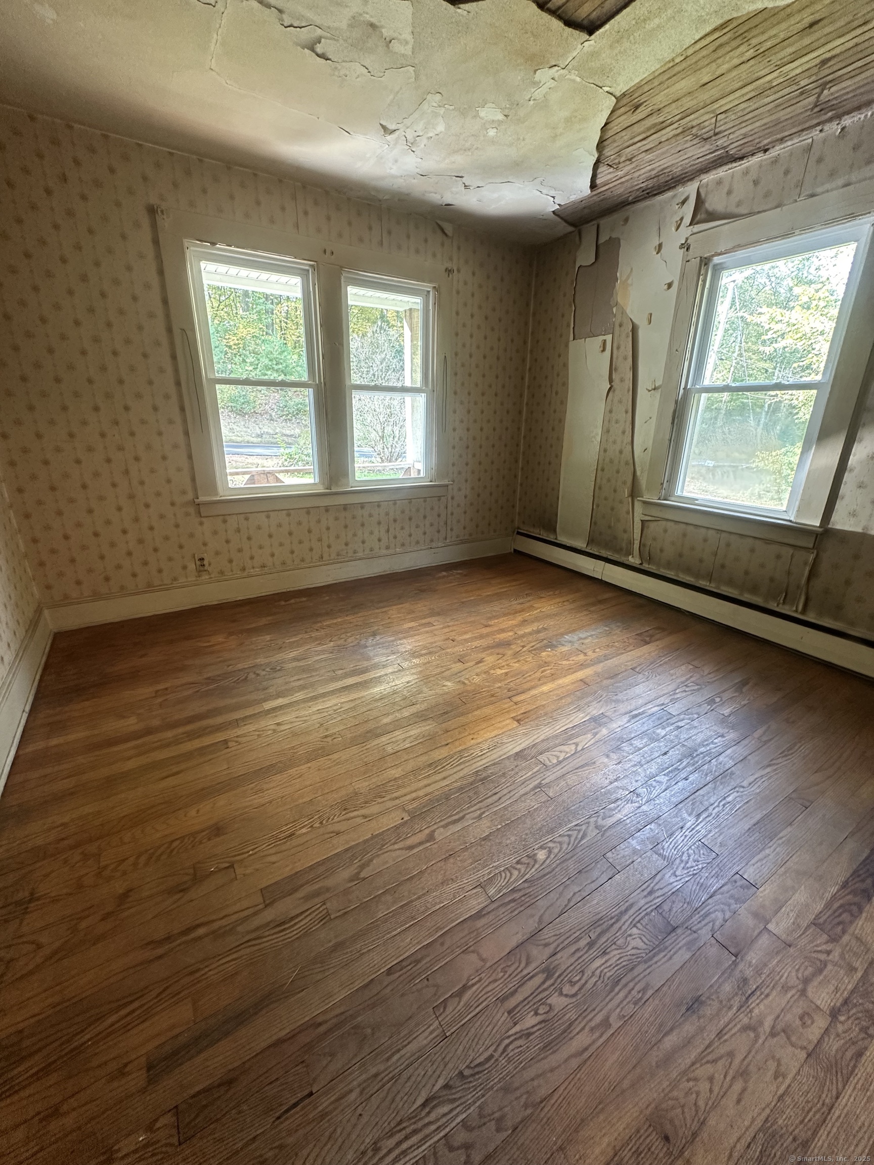 864 Boston Turnpike Coventry, CT 06238 - Photo 11 of 18 an empty room with wooden floor and windows