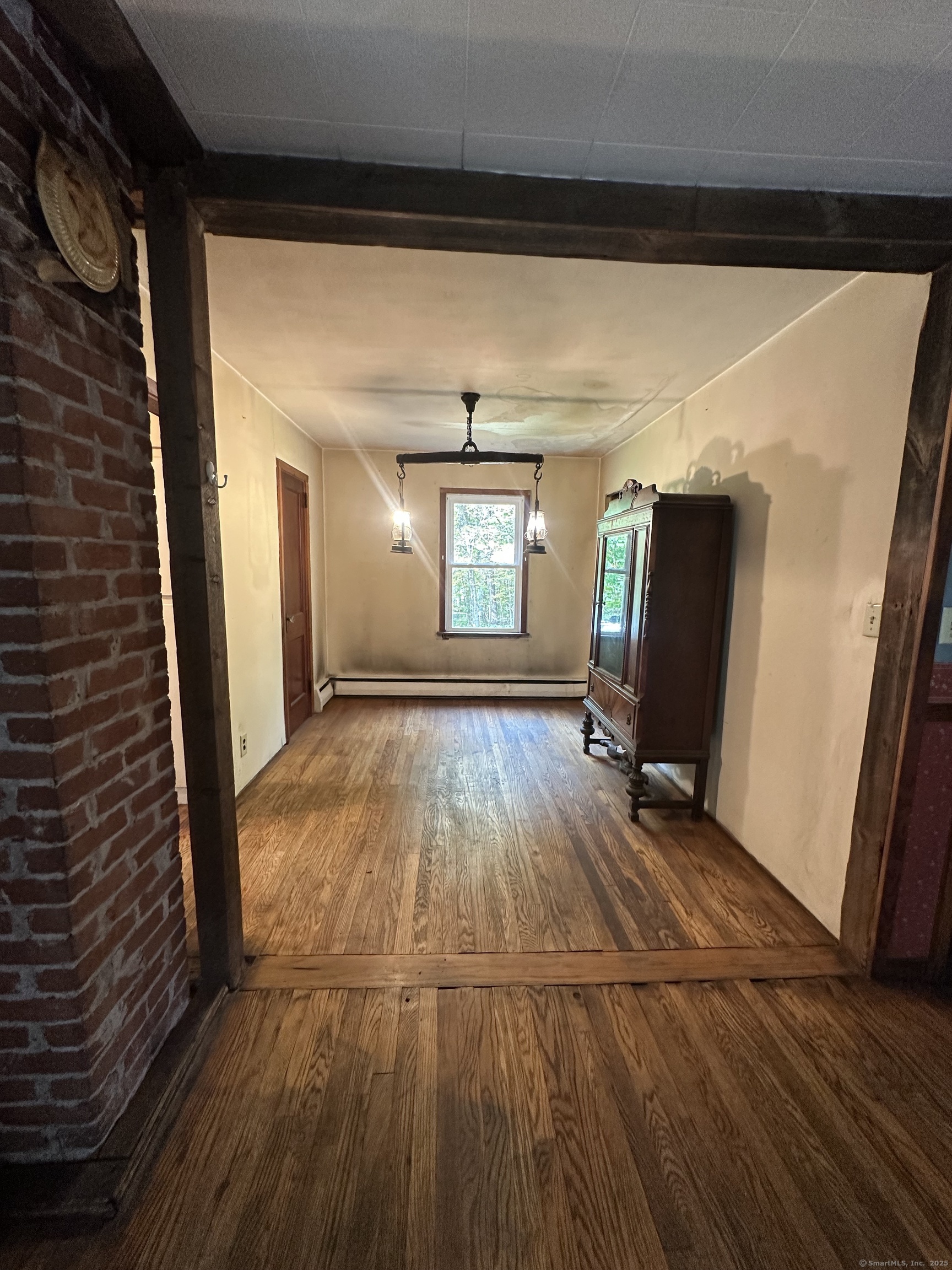 864 Boston Turnpike Coventry, CT 06238 - Photo 7 of 18 a view of a room with wooden floor and chair