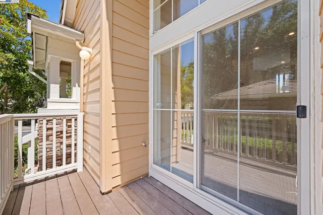 a view of a balcony with wooden floor