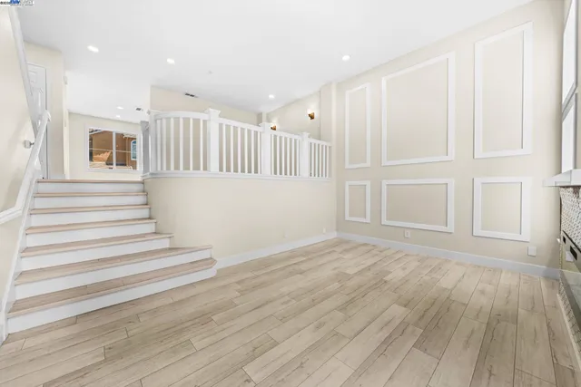 a view of front door with wooden floor and windows