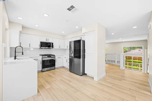a kitchen with a sink stove and refrigerator
